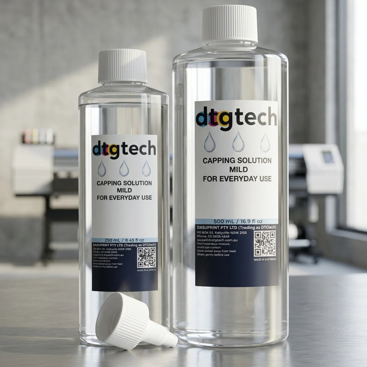 250ml & 500ml of dtgtech capping solution on a surface with a blurred office background. Value Bundle pack.